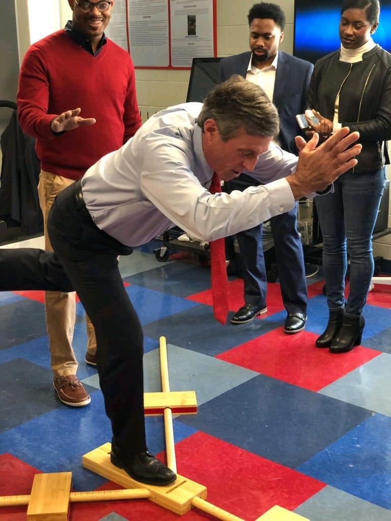 Gov. John Carney takes part in a balance simulation at Delaware State University with Homer.