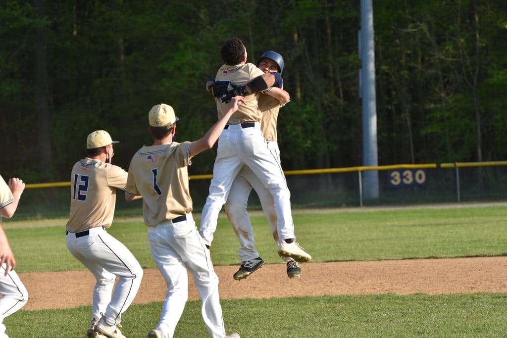 Mason DeLuca and Jackson Tyer DMA baseall chest bump after win