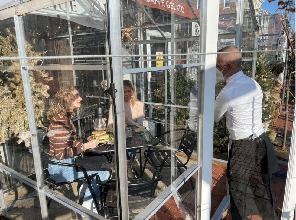 Caffe Gelato customers enjoy sun in one of its solo greenhouses