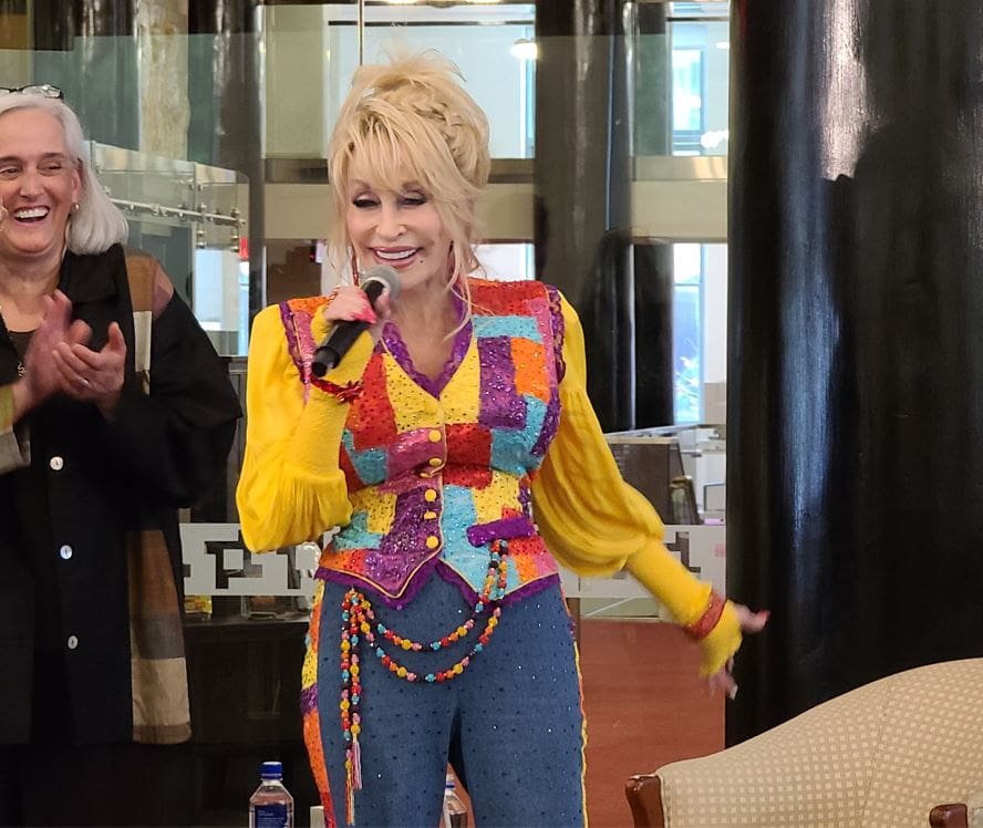 Dolly Parton standing in front of a building