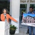 Congresswoman Lisa Blunt Rochester, D-Del., shows a photo of the Division Street building that will be constructed to house the Center for Urban Revitalization and Entrepreneurship as well as NCALL.