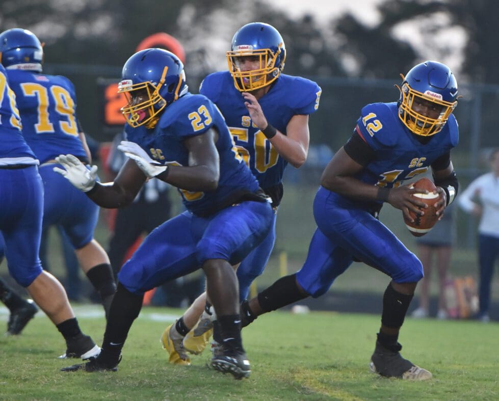 Sussex Central quarterback Troy Morris rolls out of the pocket Photo by Ben Fulton