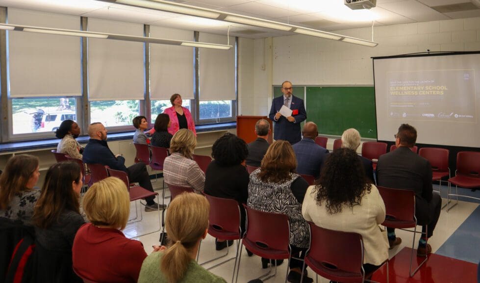The four district superintendents watch from the front row as Jon Cooper, director of student services at Colonial, announces the new wellness centers.