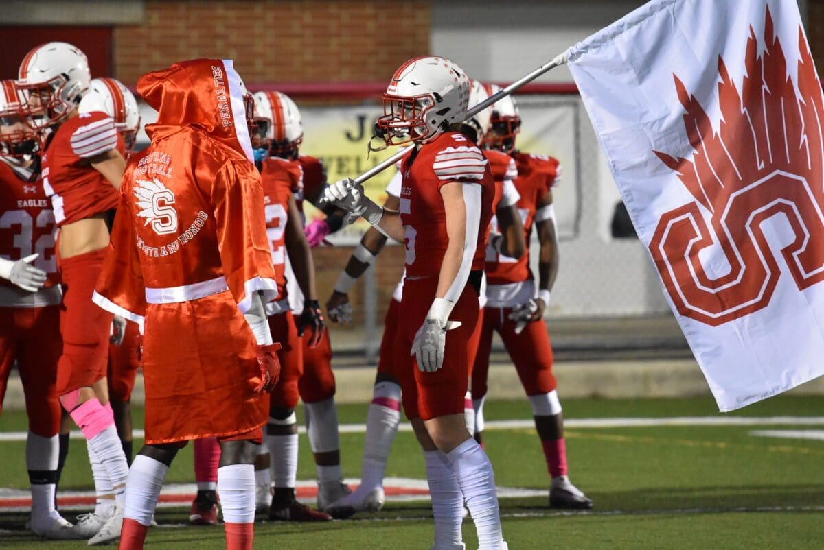 Smyrna Eagles Football player Cole Moyer holds the Smyrna Flag before the game Photo by Ben Fulton