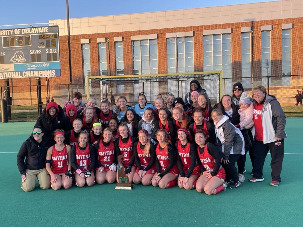 Smyrna Field Hockey posing with the state championship trophy photo by Nick Halliday