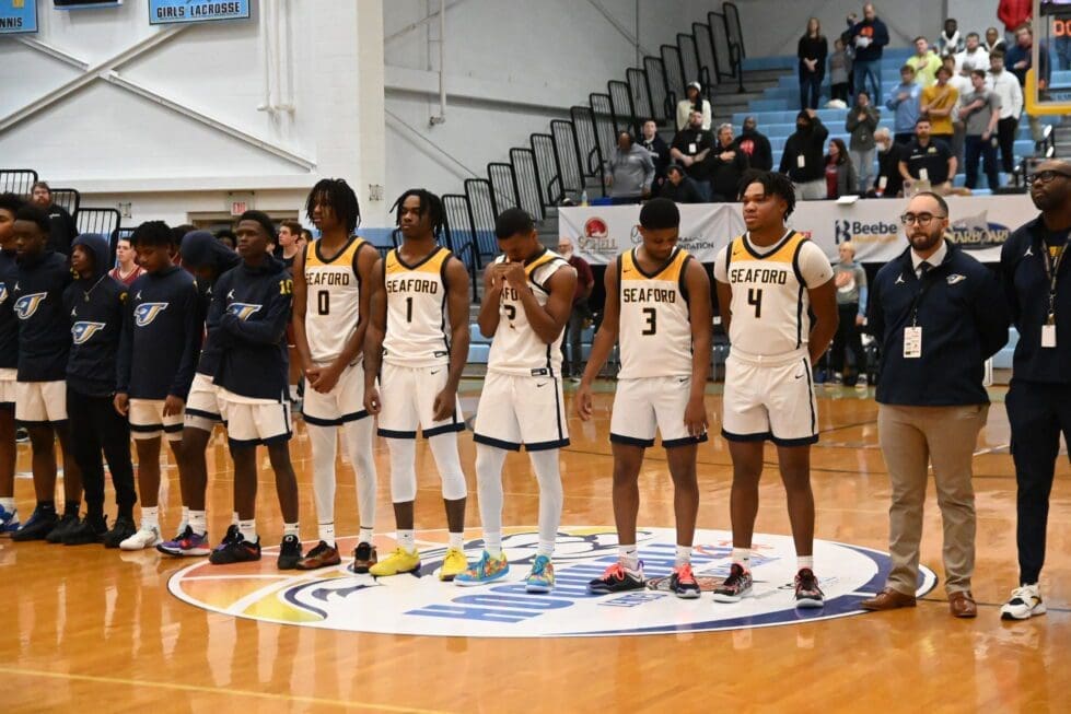 Seaford Boys basketball team standing for the National Anthem photo by Ben Fulton 2