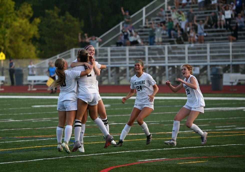 Archmere girls soccer celebrates after scoring the go ahead goal against Caravel photo courtesy of Nick Halliday