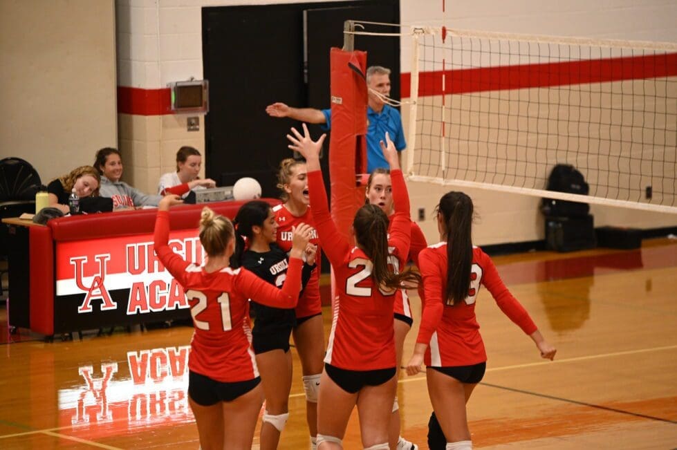 Ursuline Academy volleyball team cheers after a point photo by Nick Halliday