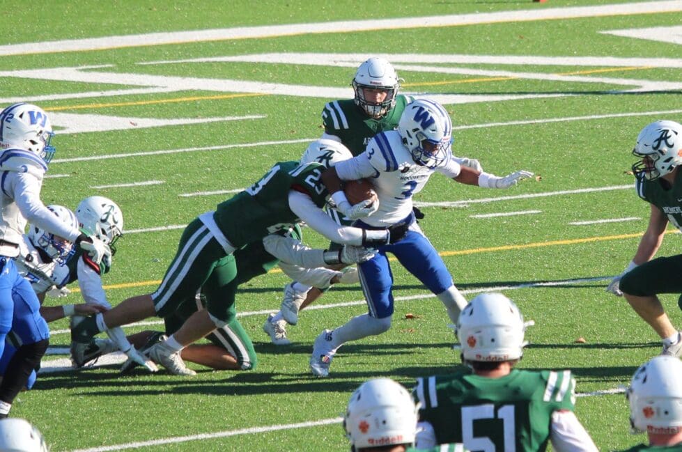 Archmere Auks football players tackle a Woodbridge player in the DIAA DII football semi final photo courtesy of Jason Winchell