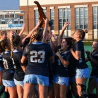 Cape Henlopen field hockey team celebrates being handed the championship trophy, photo couresy of Nick Halliday