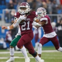 Caravel football Craig Miller runs the ball against Archmere in the DIAA 2A football state championship, photo courtesy of Donnell Henriquez