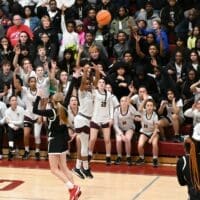 Caravel’s Chastity “Speedy” Wilson attempts a three pointer as the crowd behind her started to cheer in their win over Ursuline, photo courtesy of Nick Halliday