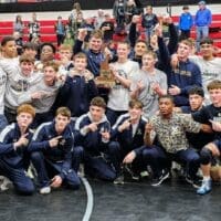 Delaware Military Academy (DMA) wrestling posing with the division II state championship trophy, photo courtesy of DMA Athletics Twitter