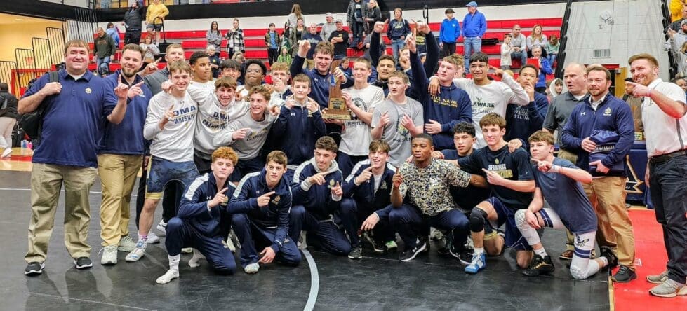 Delaware Military Academy DMA wrestling posing with the division II state championship trophy photo courtesy of DMA Athletics Twitter