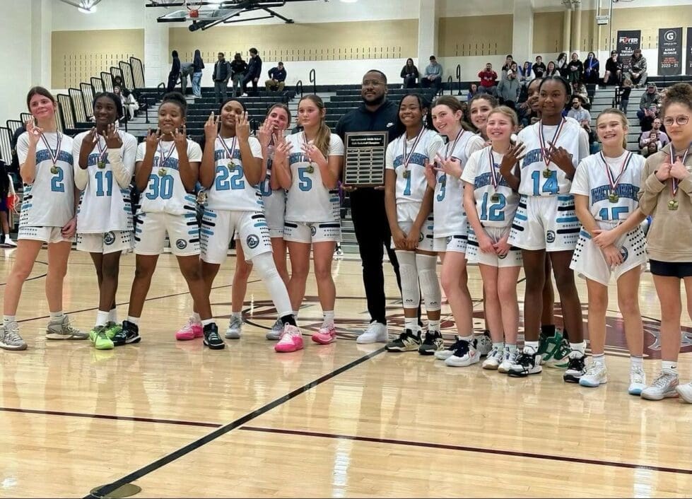 Everett Meredith Middle School girls basketball poses with the championship trophy after going a perfect 14 0 photo courtesy of Shola Cooke