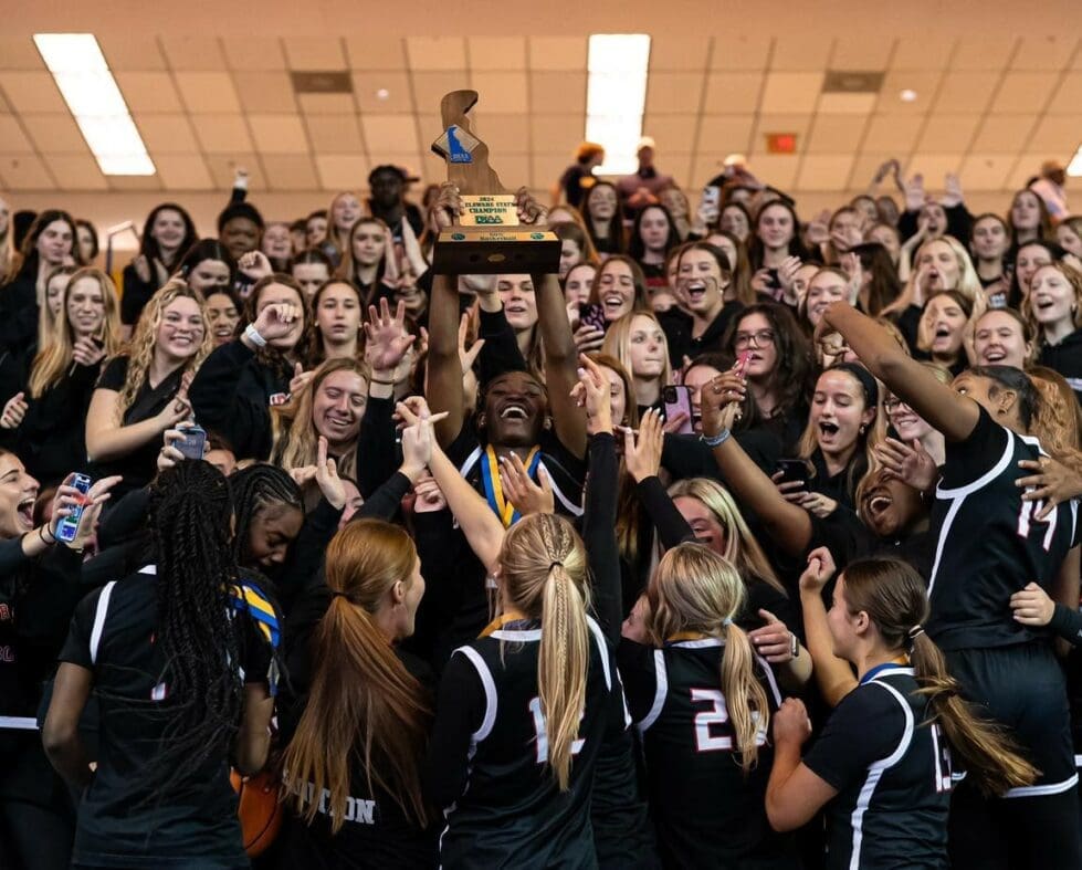 Ursuline Academy girls basketball team raises the DIAA state championship tropy with their fellow classmates photo courtesy of Ursuline Academy
