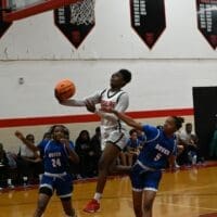 Ursuline girls basketball Jezelle “GG” Banks attempts a layup against Dover as she scored 32 points in the game, photo courtesy of Nick Halliday