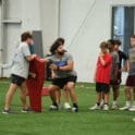 trainer teaching drills at Brian ONeills youth football camp at Titus. Photo by Ben Fulton